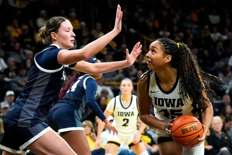 Iowa forward Hannah Stuelke (45) looks to score against Penn State forward Maggie Mendelson (4) Dec. 28, 2025 at Carver-Hawkeye Arena in Iowa City, Iowa.