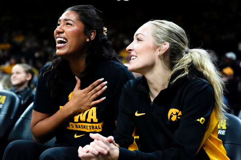 Iowa forward Jada Gyamfi (23) and Iowa guard Kylie Feuerbach (4) react during a game against the Penn State Nittany Lions on Dec. 28, 2025 at Carver-Hawkeye Arena in Iowa City, Iowa.