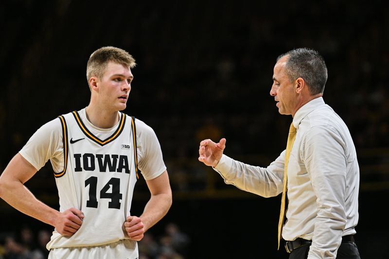 Dec 29, 2025; Iowa City; Iowa Hawkeyes guard Bennett Stirtz (14) and head coach Ben McCollum talk during the first half against the UMass Lowell River Hawks at Carver-Hawkeye Arena.