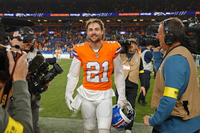 Jan 4, 2026; Denver, Colorado, USA; Denver Broncos cornerback Riley Moss (21) smiles after winning the game against the Los Angeles Chargers at Empower Field at Mile High. Mandatory Credit: Isaiah J. Downing-Imagn Images