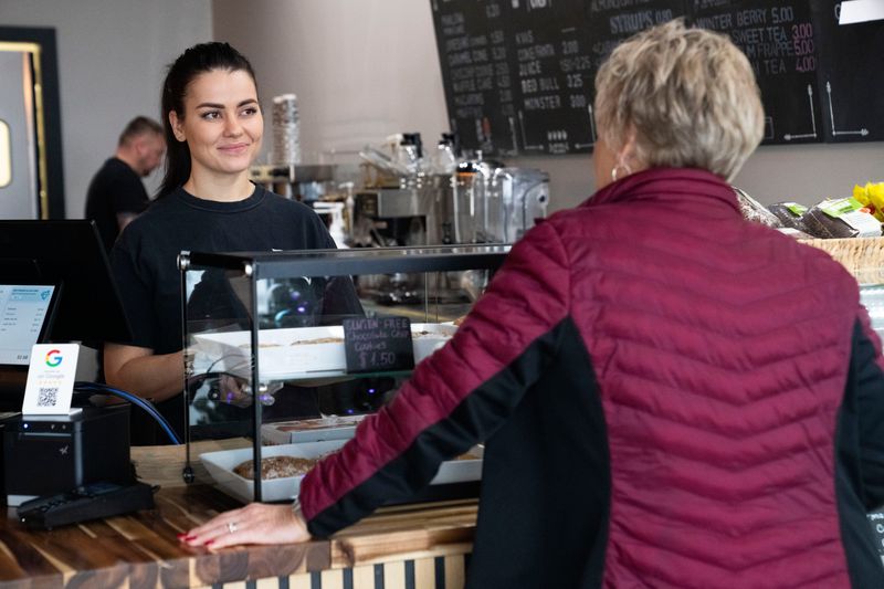 European Taste owner Alina Dvorschii talks with a customer at European Taste on Tuesday, Jan. 6, 2026, in Grimes.