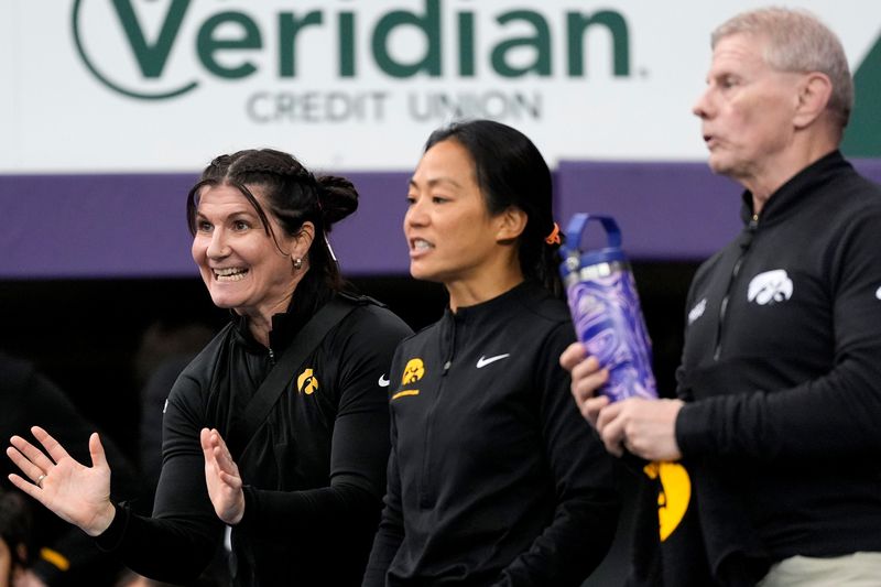 Iowa coaches, from left, Tonya Verbeek, Clarissa Chun and Gary Mayabb react Jan. 10, 2026 during a National Duals third-place match at the UNI-Dome in Cedar Falls, Iowa.