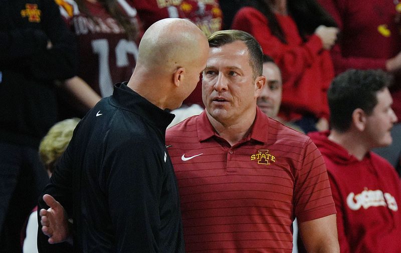 Iowa State Cyclones men's basketball head coach T.J. Otzelberger greets Oklahoma State Cowboys men's basketball head coach Steve Lutz before Iowa State and Oklahoma State men’s basketball on Jan. 10, 2026, at Hilton Coliseum in Ames, Iowa.
