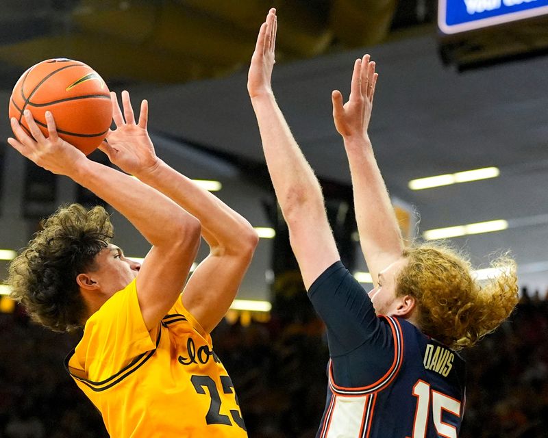 Iowa guard Isaia Howard (23) drives to the basket against Illinois forward Jake Davis (15) Jan. 11, 2026 at Carver-Hawkeye Arena in Iowa City, Iowa.