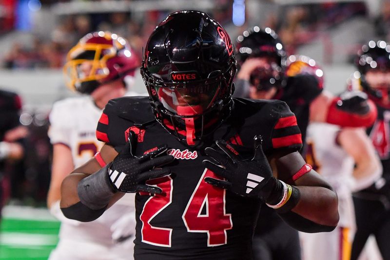 University of South Dakota Coyotes running back L.J. Phillips Jr. (24) does chest pats for scoring in the end zone on Thursday, Aug. 29, 2024, at the Dakota Dome in Vermillion, South Dakota.