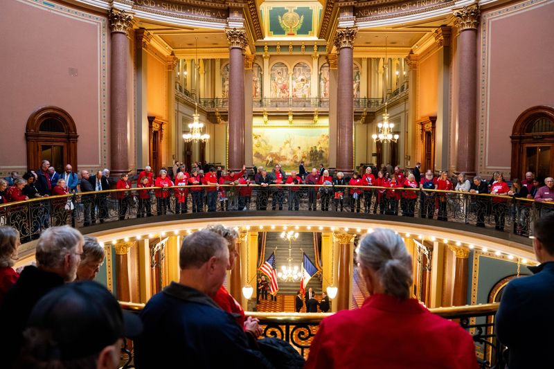 Iowa landowners bow their heads in prayer as they lobby their legislators on the use of eminent domain on private property on Jan. 13, 2026, at the Iowa State Capitol.