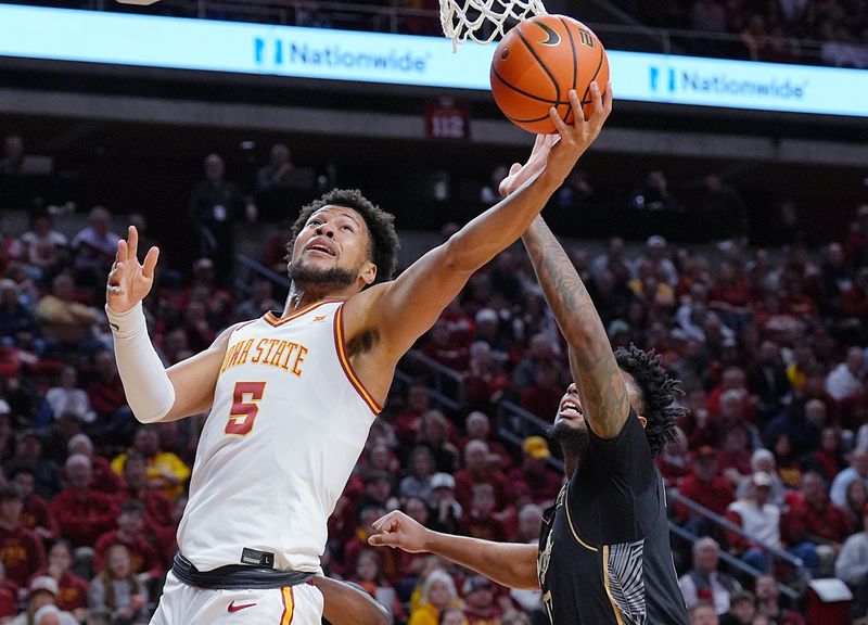 Iowa State Cyclones forward Joshua Jefferson (5) goes for a layup around UCF Knights forward Jordan Burks (99) during the first half in the Big-12 conference men’s basketball on Jan. 20, 2026, at Hilton Coliseum in Ames, Iowa.