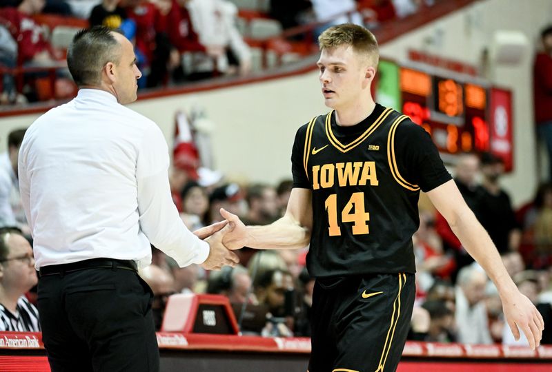 Jan 17, 2026; Bloomington, Indiana, USA; Iowa Hawkeyes guard Bennett Stirtz (14) greets Iowa Hawkeyes head coach Ben McCollum during the second half at Simon Skjodt Assembly Hall. Mandatory Credit: Robert Goddin-Imagn Images