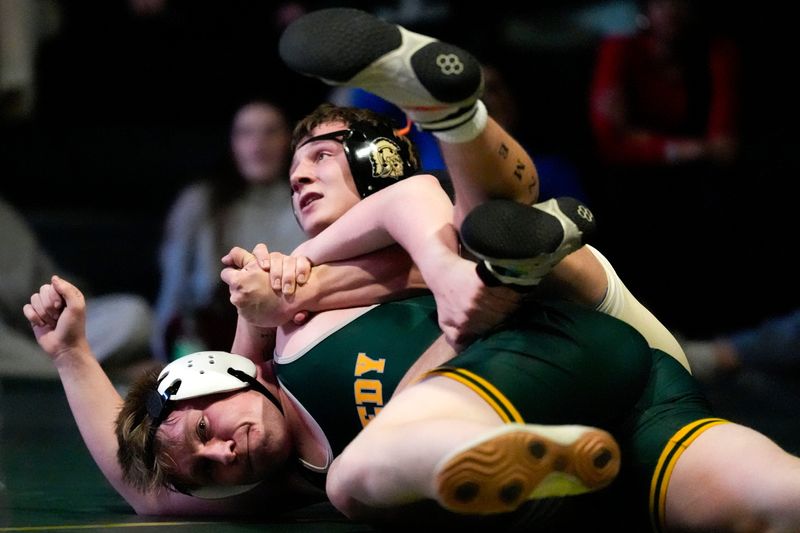 Iowa City West’s Campbell Janis wrestles Cedar Rapids Kennedy’s Waker Black in a 165-pound match Jan. 22, 2026 during a wrestling dual in Iowa City, Iowa.