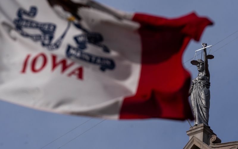 The Iowa state flag flies in front of the Dallas County Courthouse on Jan. 22, 2026, in Adel.