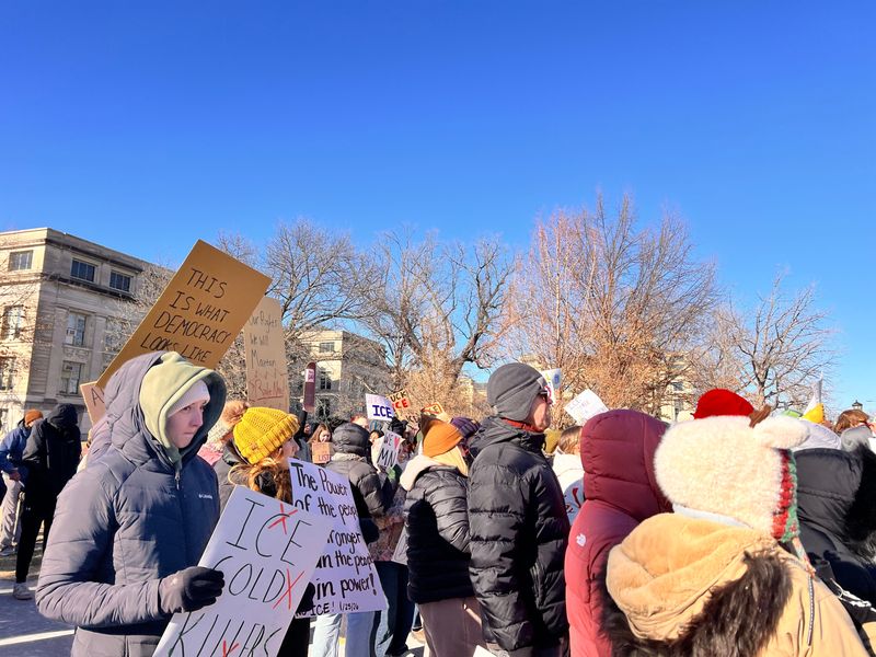 Protesters gather for a protest to dennounce ICE and honor Alex Pretti, a man shot by ICE in Minneapolis over the weekend, Jan. 25, 2026 at the Pentecrest in Iowa City, Iowa.