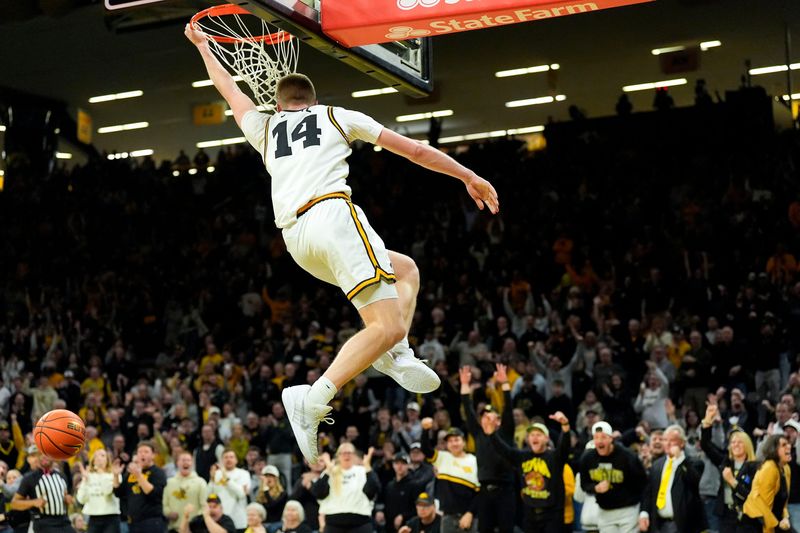 Iowa guard Bennett Stirtz (14) dunks to give the Iowa Hawkeyes their first lead against the USC Trojans Jan. 28, 2026 at Carver-Hawkeye Arena in Iowa City, Iowa.