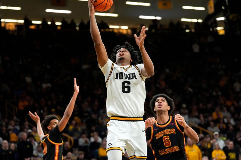 Iowa’s Tavion Banks (6) drives to the basket against the USC Trojans Jan. 28, 2026 at Carver-Hawkeye Arena in Iowa City, Iowa.