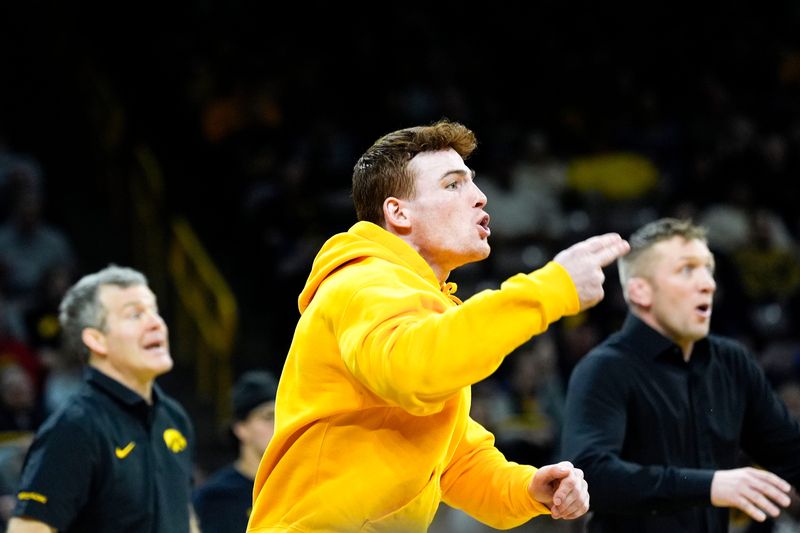 Iowa’s Michael Caliendo supports Iowa’s Harvey Ludington in his 197-pound match against Minnesota’s Gavin Nelson Jan. 30, 2026 at Carver-Hawkeye Arena in Iowa City, Iowa.