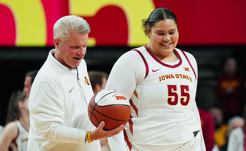 Iowa State Cyclones' center Audi Crooks (55) receives the ball from head coach Bill Fennelly in honor her 2000- career point before Iowa State and UFC women’s basketball on Jan. 31, 2026, at Hilton Coliseum in Ames, Iowa.