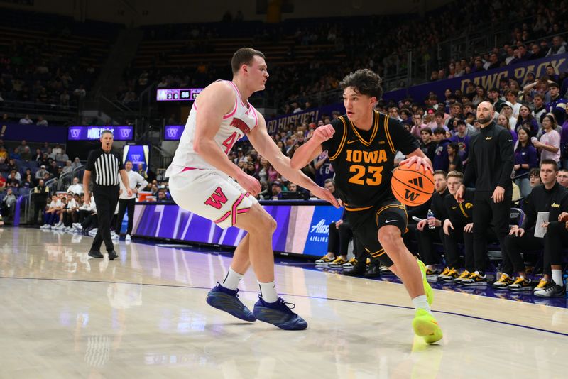 Feb 4, 2026; Seattle, Washington, USA; Iowa Hawkeyes guard Isaia Howard (23) dribbles the ball while guarded by Washington Huskies forward Jacob Ognacevic (41) during the second half at Alaska Airlines Arena at Hec Edmundson Pavilion. Mandatory Credit: Steven Bisig-Imagn Images