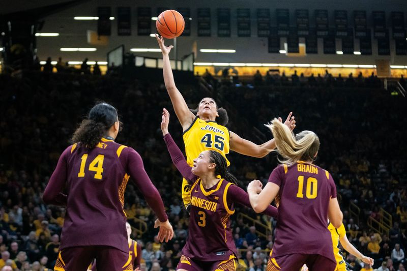 Iowa forward Hannah Stuelke (45) reaches for an offensive rebound during a game against Minnesota on Feb. 5, 2026, at Carver-Hawkeye Arena.