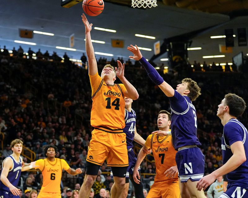 Iowa guard Bennett Stirtz (14) shoots the basketball against the Northwestern Wildcats Feb. 8, 2026 at Carver-Hawkeye Arena in Iowa City, Iowa.