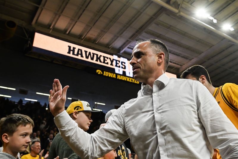 Feb 8, 2026; Iowa City, Iowa, USA; Iowa Hawkeyes head coach Ben McCollum reacts with fans after the game against the Northwestern Wildcats at Carver-Hawkeye Arena. Mandatory Credit: Jeffrey Becker-Imagn Images
