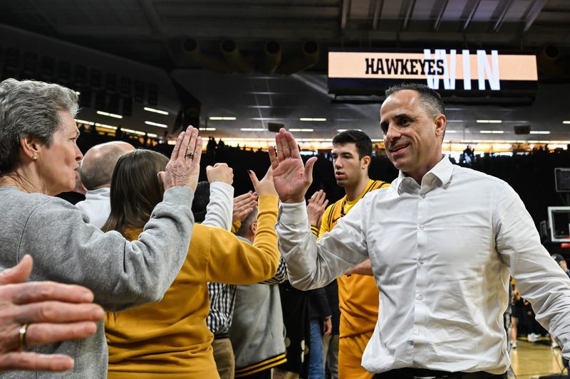 Feb 8, 2026; Iowa City, Iowa, USA; Iowa Hawkeyes head coach Ben McCollum reacts with fans after the game against the Northwestern Wildcats at Carver-Hawkeye Arena. Mandatory Credit: Jeffrey Becker-Imagn Images