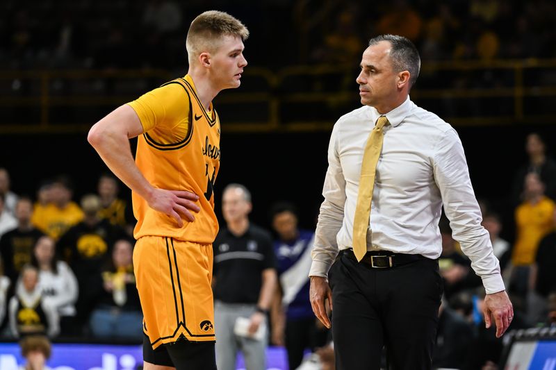 Feb 8, 2026; Iowa City, Iowa, USA; Iowa Hawkeyes guard Bennett Stirtz (14) and head coach Ben McCollum talk during the second half against the Northwestern Wildcats at Carver-Hawkeye Arena. Mandatory Credit: Jeffrey Becker-Imagn Images