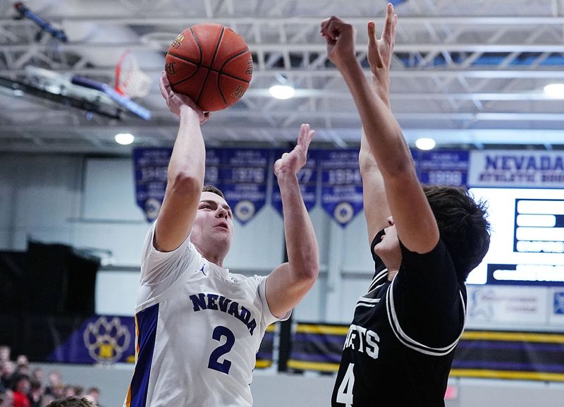 Nevada guard Kole Beving (2) shoots the ball against Iowa Falls-Alden's Brody McNeal (4) during the first quarter of the Cubs' 81-26 victory in boys basketball on February 9 at Nevada High School in Nevada, Iowa.