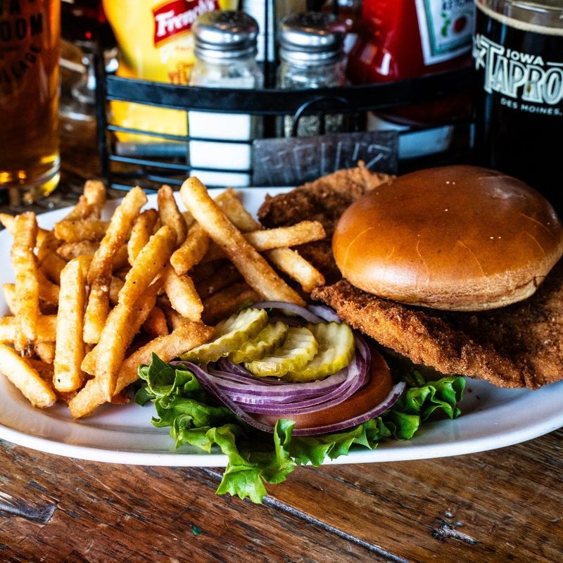 Expect a crisp, hand-breaded pork cutlet served on a soft bun that complements the meat’s golden crust with the breaded pork tenderloin at the Iowa Taproom in the East Village of Des Moines.