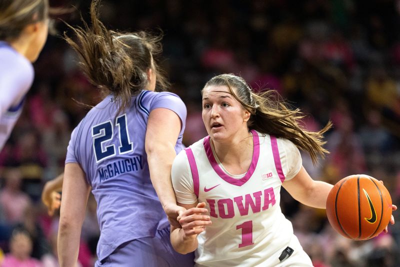 Iowa guard Taylor Stremlow (1) drives toward the basket against Washington forward Brynn McGaughy (21) Feb. 11, 2026 at Carver-Hawkeye Arena in Iowa City, Iowa.