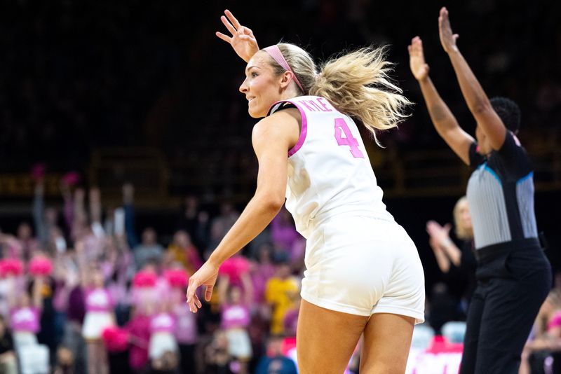 Iowa guard Kylie Feuerbach (4) reacts after making a 3-pointer against the Washington Huskies Feb. 11, 2026 at Carver-Hawkeye Arena in Iowa City, Iowa.