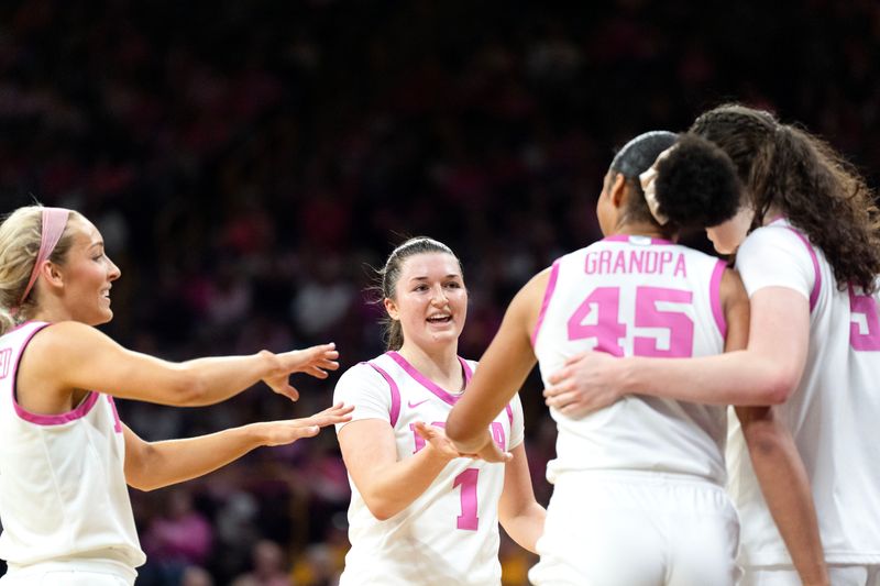 Iowa guard Kylie Feuerbach (4), Iowa guard Taylor Stremlow (1), Iowa forward Hannah Stuelke (45) and Iowa center Ava Heiden (5) huddle during a game against the Washington Huskies on Feb. 11, 2026 at Carver-Hawkeye Arena in Iowa City, Iowa.