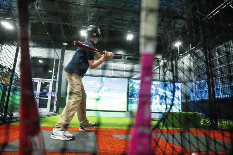People try the new batting simulator at Smash Park on Feb. 12, 2026, in West Des Moines.
