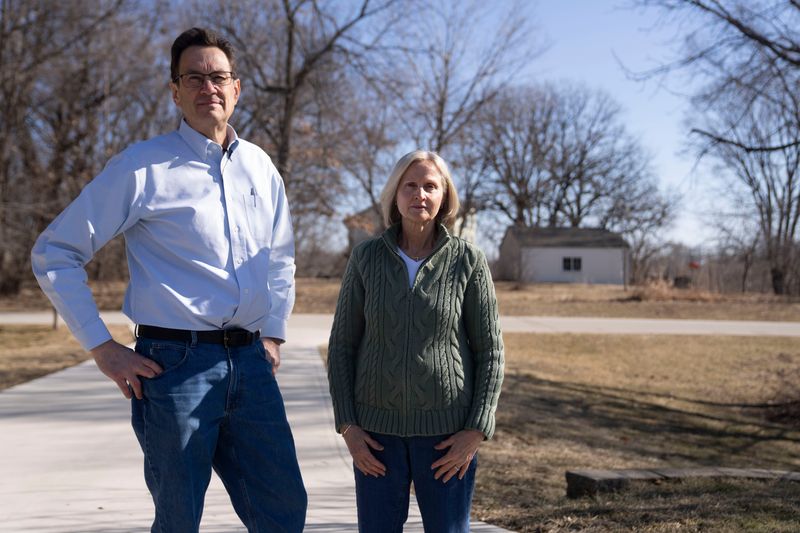 Robert and Susan Lankford stand for a portrait in the driveway of their Ankeny home on Friday, Feb. 13, 2026 in Ankeny.