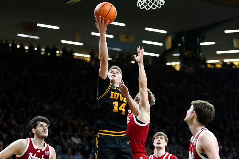 Iowa guard Bennett Stirtz (14) drives to the basket against the Nebraska Cornhuskers Feb. 17, 2026 at Carver-Hawkeye Arena in Iowa City, Iowa.