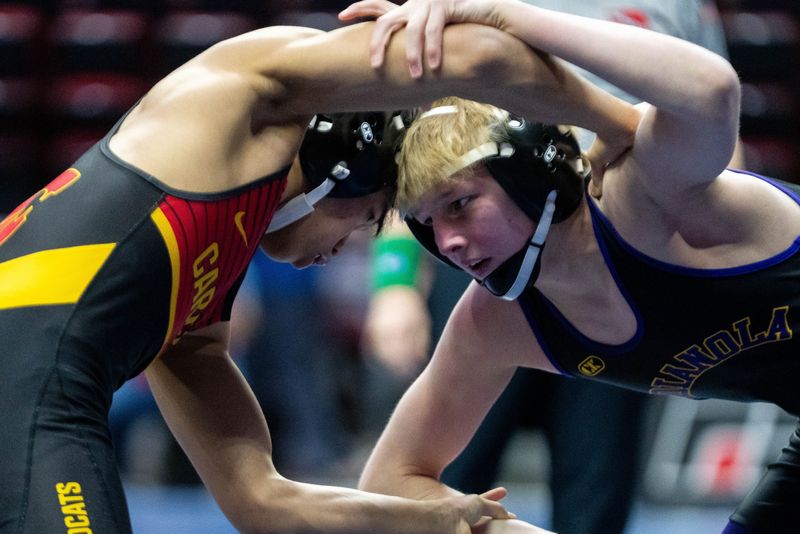 Carlisle’s Maxwell Baccam wrestles Indianola’s Cain Crosson at 113 lbs. on Feb. 18, 2026, at Casey’s Center in Des Moines.