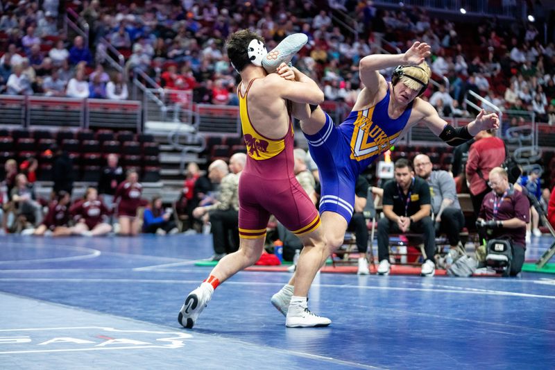 Ankeny’s Calvin Rathjen wrestles Waukee’s Kayden Crispin at 165 lbs. on Feb. 18, 2026, at Casey’s Center in Des Moines.