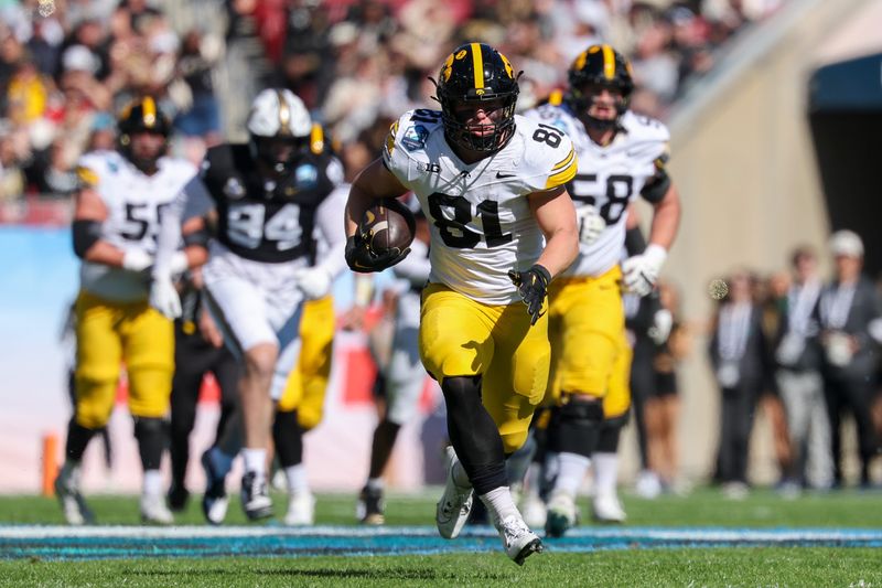 Dec 31, 2025; Tampa, FL, USA; Iowa Hawkeyes tight end DJ Vonnahme (81) runs with the ball against the Vanderbilt Commodoresin the first quarter during the ReliaQuest Bowl at Raymond James Stadium. Mandatory Credit: Nathan Ray Seebeck-Imagn Images