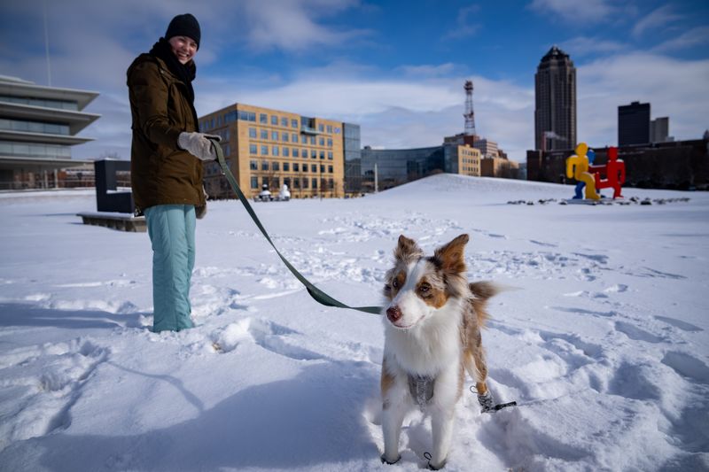 Irene Abbott and Riley, her one and a half year old Australian Shepard play in the snow at the Pappajohn Sculpture Park, Feb. 20, 2026.
