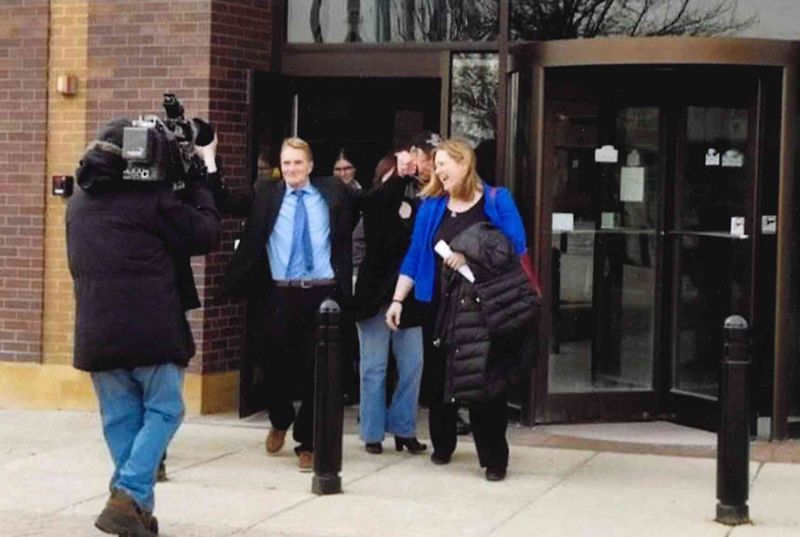 William "Bill" Amor walks out of the DuPage County, Illinois, courthouse a free man on Feb. 21, 2018, after 22 years in prison for a crime he did not commit. Beside him is attorney Erica Nichols Cook, who later founded a wrongful convictions clinic at Drake University.