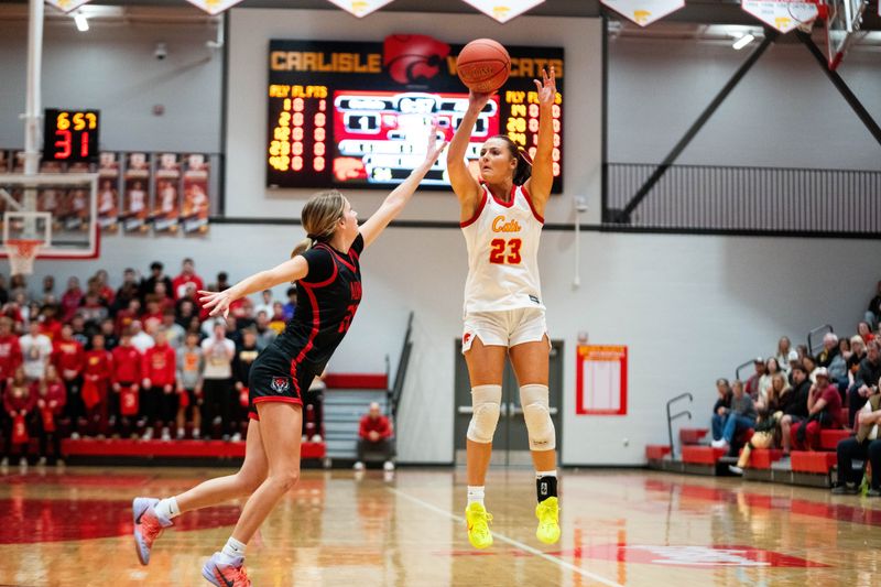 Carlisle's Macy Comito (23) shoots the ball from three-point range against ADM's Brecken Morse (20) on Feb. 24, 2026, at Carlisle High School.