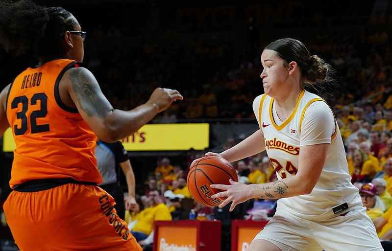 Iowa State Cyclones' forward Addy Brown (24) drives with the ball around Oklahoma State Cowgirls guard Stailee Heard (32) during the first quarter in the senior day women basketball at Hilton Coliseum on February. 25, 2026, in Ames, Iowa.