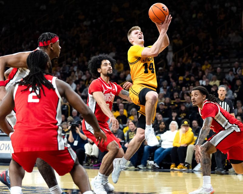 Iowa guard Bennett Stirtz (14) drives to the basket against the Ohio State Buckeyes Feb. 25, 2026 at Carver-Hawkeye Arena in Iowa City, Iowa.