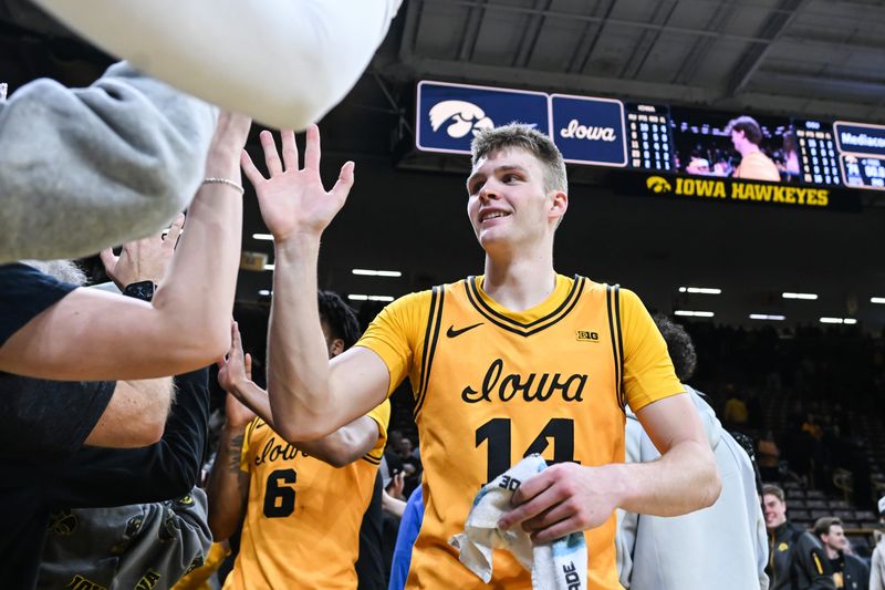 Feb 25, 2026; Iowa City, Iowa, USA; Iowa Hawkeyes guard Bennett Stirtz (14) reacts with fans after the game against the Ohio State Buckeyes at Carver-Hawkeye Arena. Mandatory Credit: Jeffrey Becker-Imagn Images