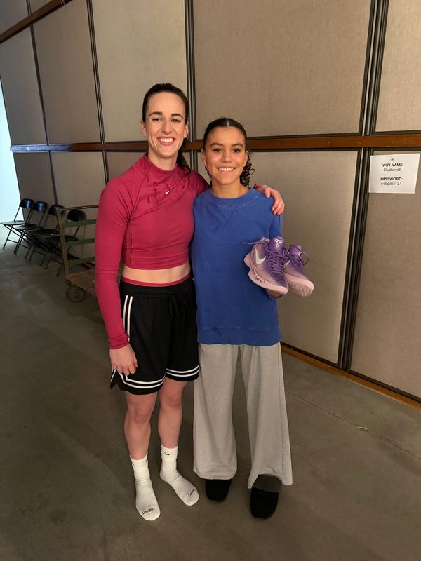 Britt Schellhammer poses for a picture with Caitlin Clark after appearing in a Gatorade commercial together. Clark later gave her a pair of autographed Nikes.