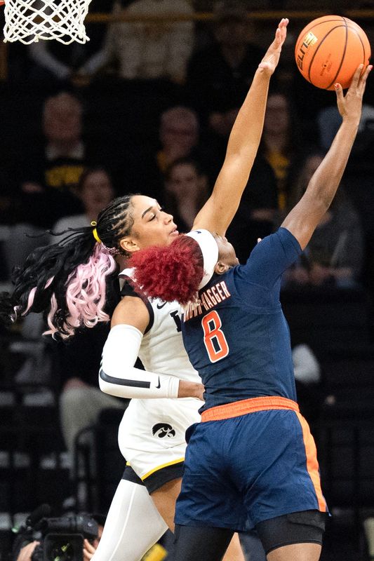 Iowa forward Hannah Stuelke (45) defends a shot attempt by Illinois guard Jasmine Brown-Hagger (8) Feb. 26, 2026 at Carver-Hawkeye Arena in Iowa City, Iowa.