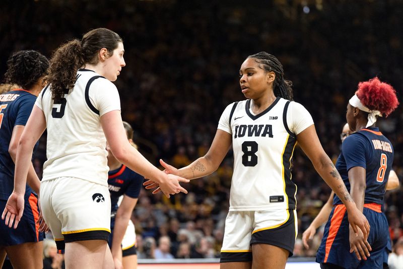 Iowa center Ava Heiden (5) high-fives Iowa guard Journey Houston (8) during a game against the Illinois Fighting Illini on Feb. 26, 2026, at Carver-Hawkeye Arena in Iowa City, Iowa.
