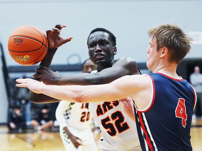 Ames center DJ Bijiek (52) draws contact from Urbandale's Davis Hardersen (4) on a drive during the second quarter of the Little Cyclones' 48-43 loss to the J-Hawks in the Class 4A boys basketball Substate 2 final on March 3 at the Harrison Barnes Gymnasium and Court in Ames, Iowa.