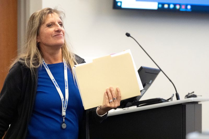 Interim CFO Kim Michael-Lee leaves the podium after speaking March 3, 2026 during a special board meeting of the Iowa City Community School District in Iowa City, Iowa.