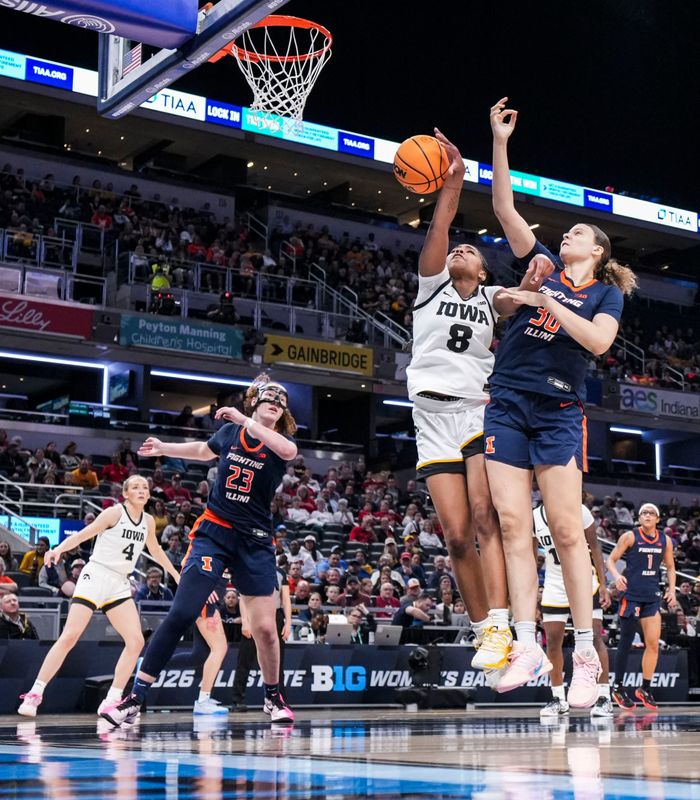 Iowa Hawkeyes guard Journey Houston (8) and Illinois Fighting Illini forward Cearah Parchment (30) go for the rebound Friday, March 6, 2026, during a Big Ten women's basketball tournament game at Gainbridge Fieldhouse in Indianapolis.