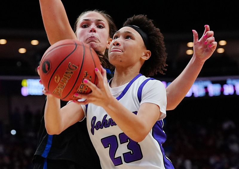 Johnston guard Jaliyah Kinnetz (23) shoots the ball around Waukee Northwest guard Vana Bilic (22) during the fourth quarter in the 5A girls high school state basketball championship game on March 6, 2026, at Casey’s Center in Des Moines, Iowa.