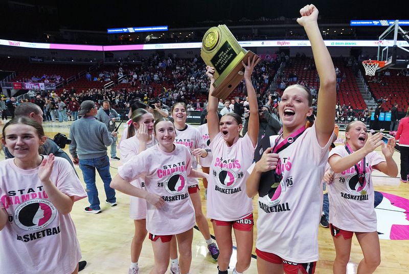 The Maquoketa girls basketball team celebrates with its Class 3A IGHSAU basketball state championship trophy after the Cardinals defeated Mount Vernon, 59-42, in the championship game on March 6 at the Casey’s Center in Des Moines.